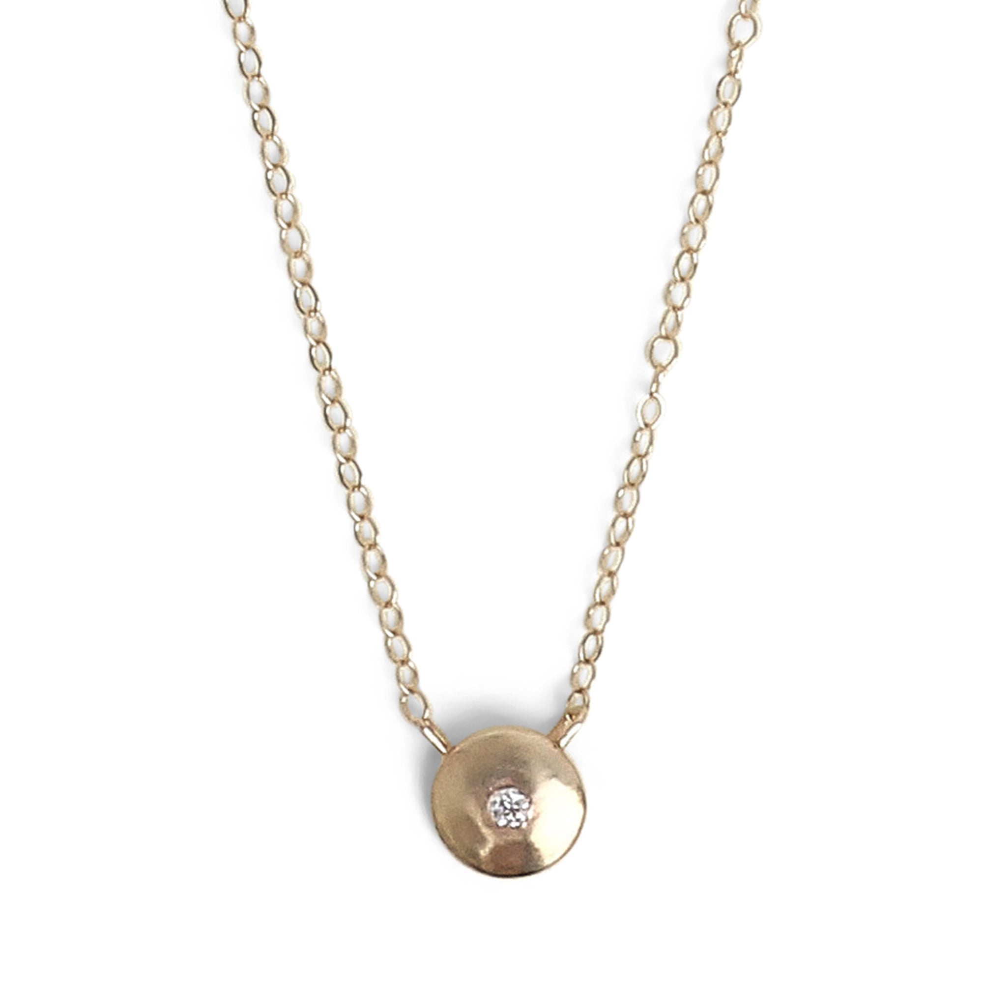 Simple yet striking, the Mini Disc Necklace highlights a single 0.03 tcw diamond, flush set in 14K gold.
