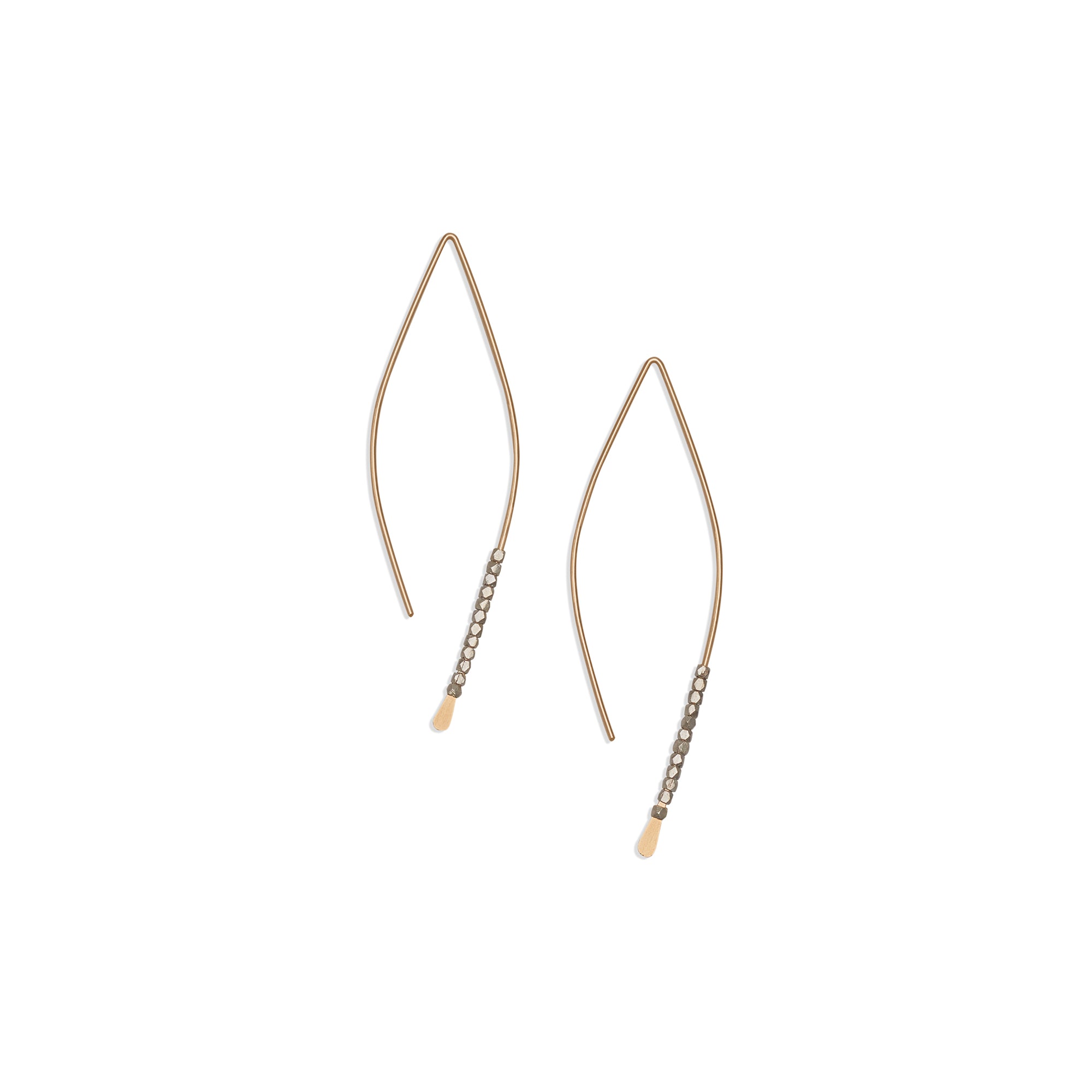 The thin, hammered wire of the Bead Crescent earrings creates a smooth marquise shape, adorned with sterling silver beads