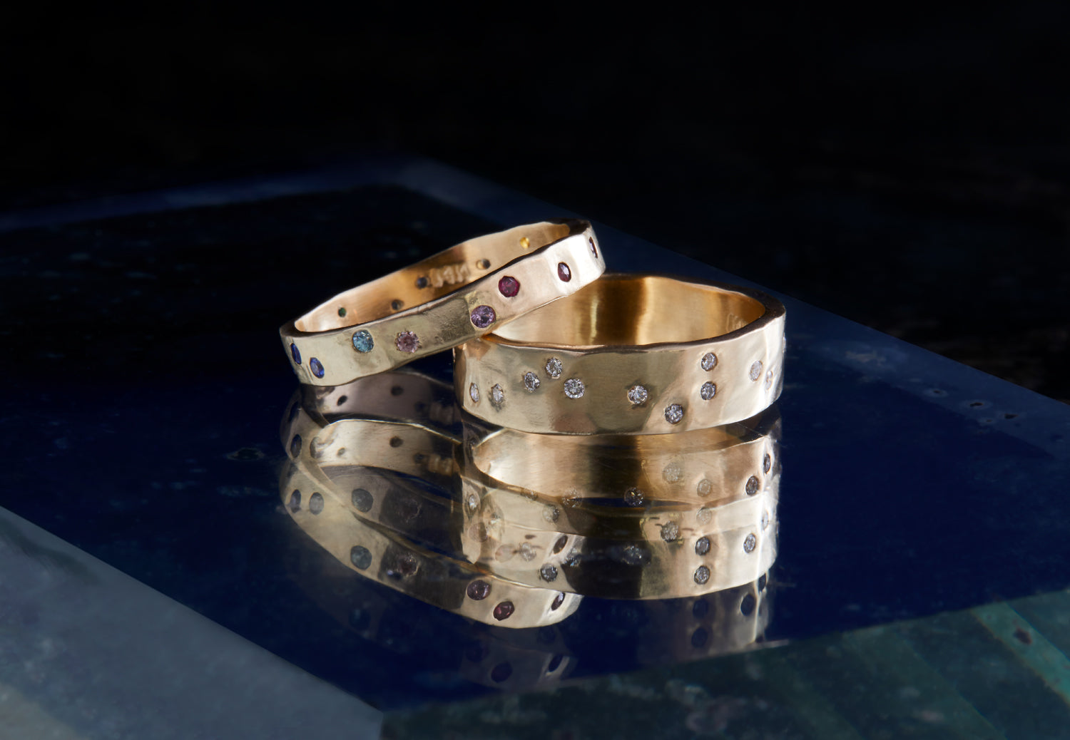 The Wide Constellation Band showcases 14 diamonds scattered across the front of a wide hammered band.
