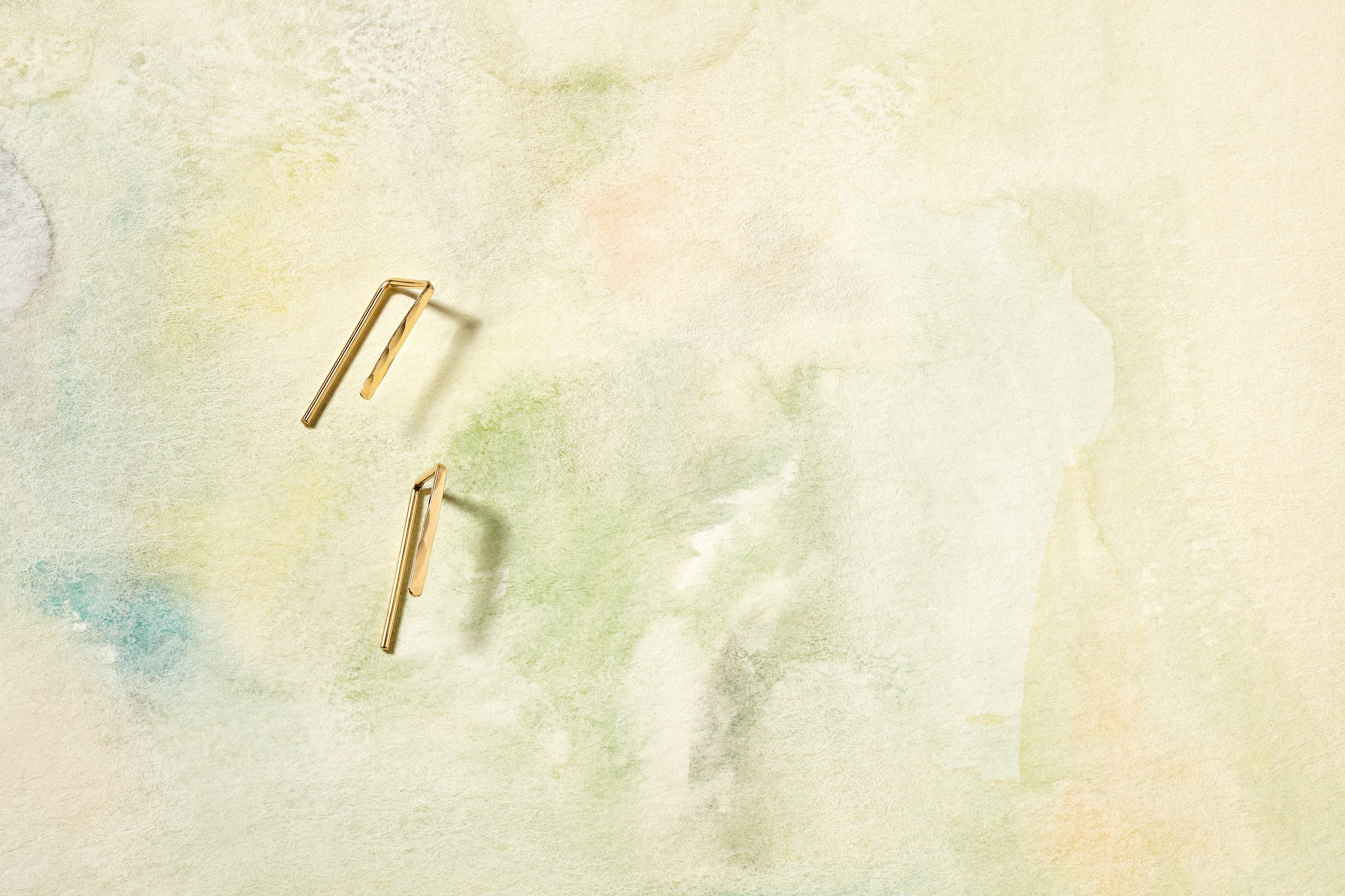 The Staple Hook, a modern threader earring in 14k gold with your choice of classic hammered textured or nugget texture