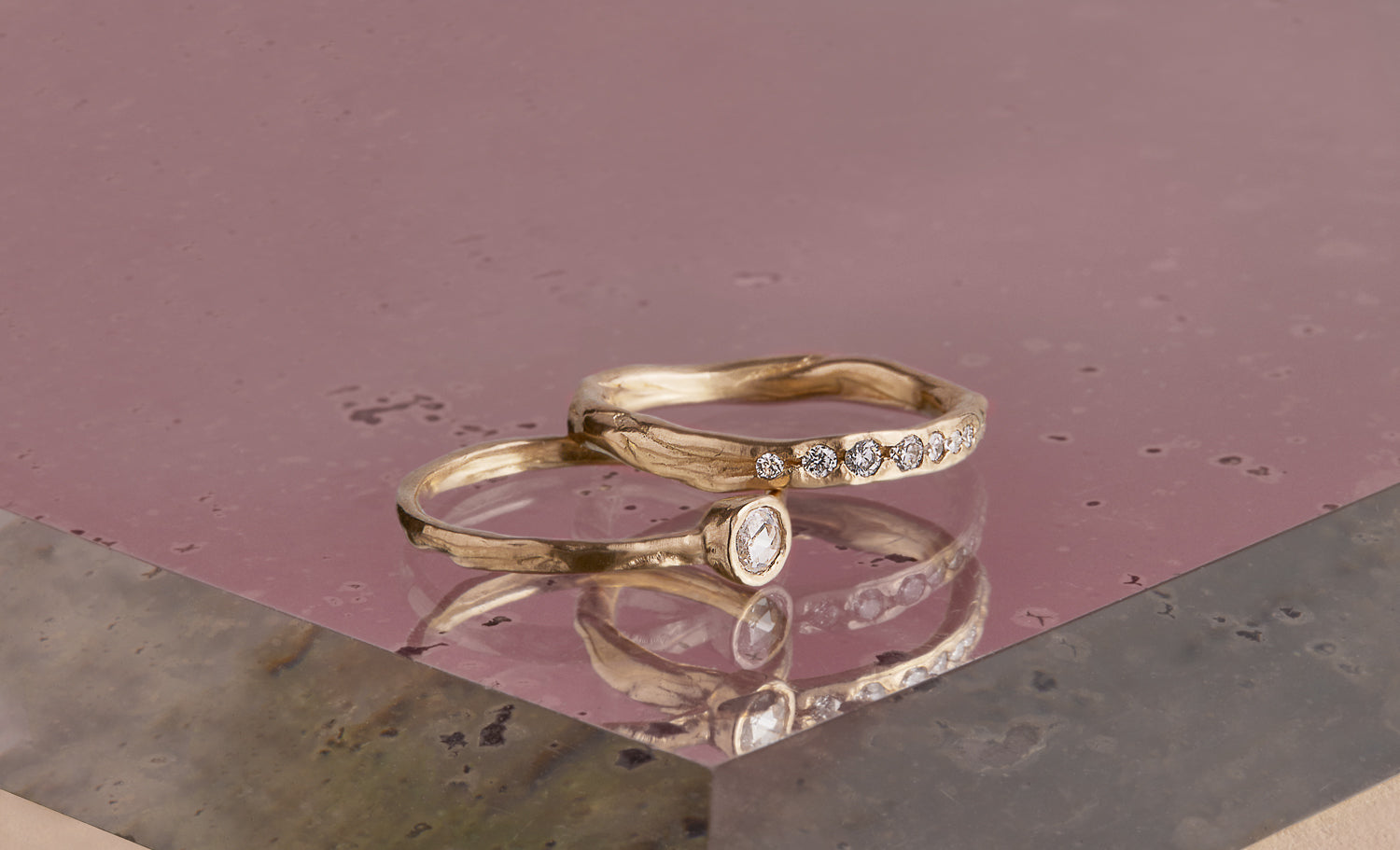 The unique Barrier band showcases seven graduated white diamonds, set across the front of an organic 14k band