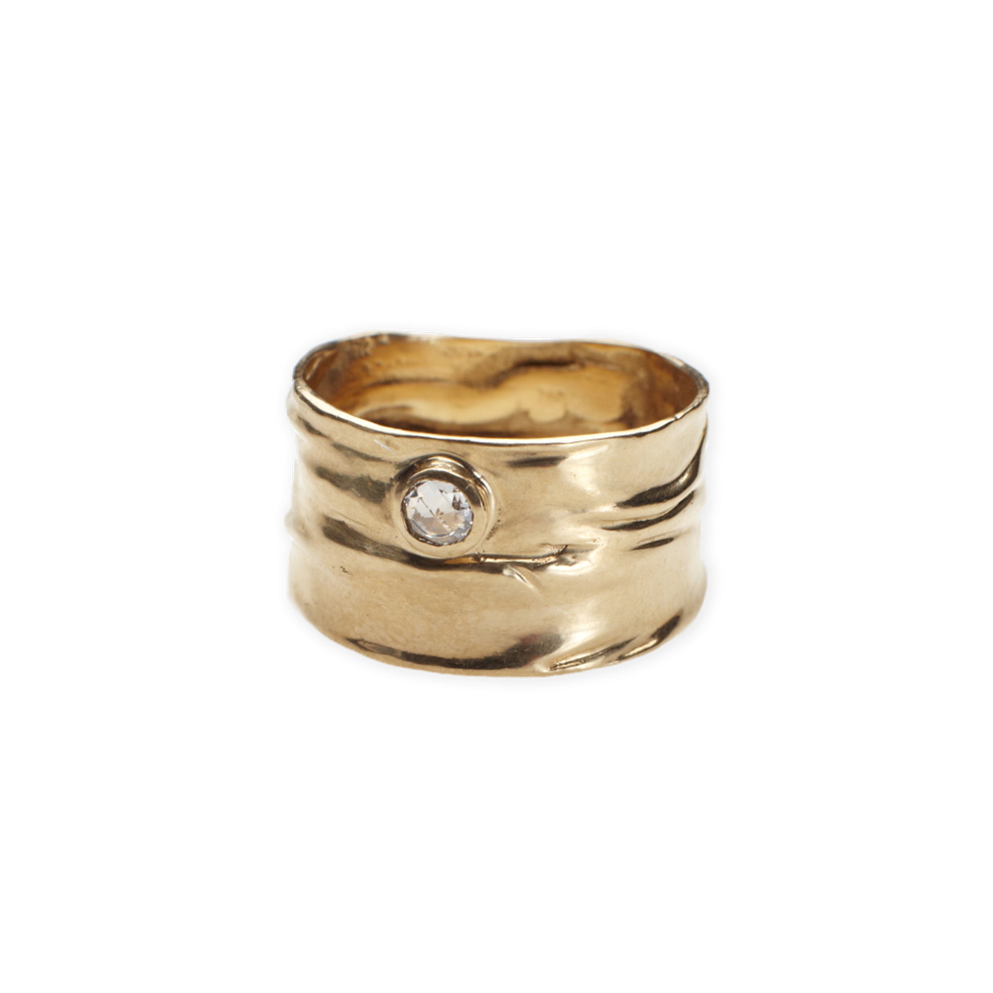 The Atol Ring features an organic, wide 14k gold band with a bezel set rose cut diamond.
