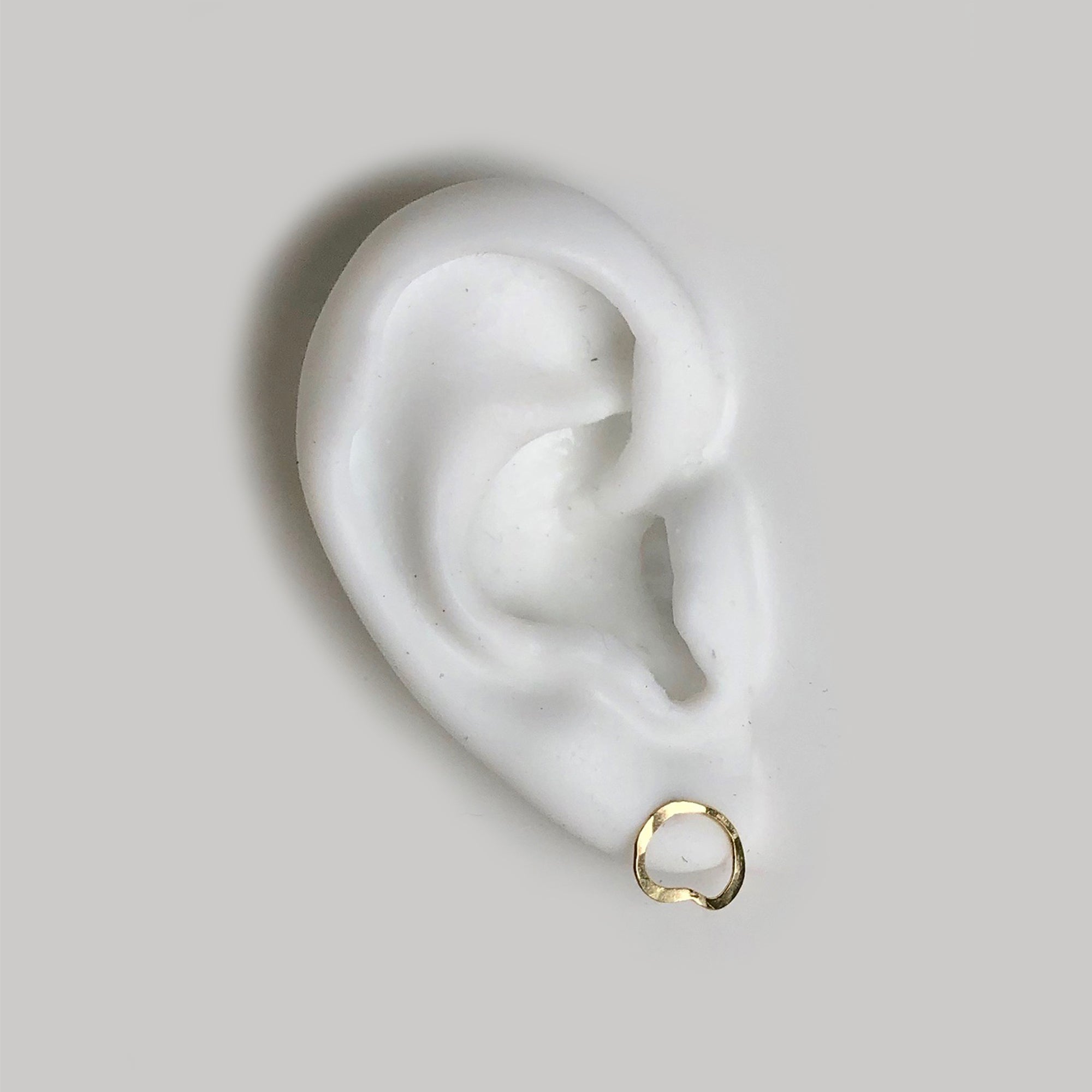 One-of-a-kind, 14k gold set features organic hand forged studs inspired by our collaboration with artist Callen Thompson 
