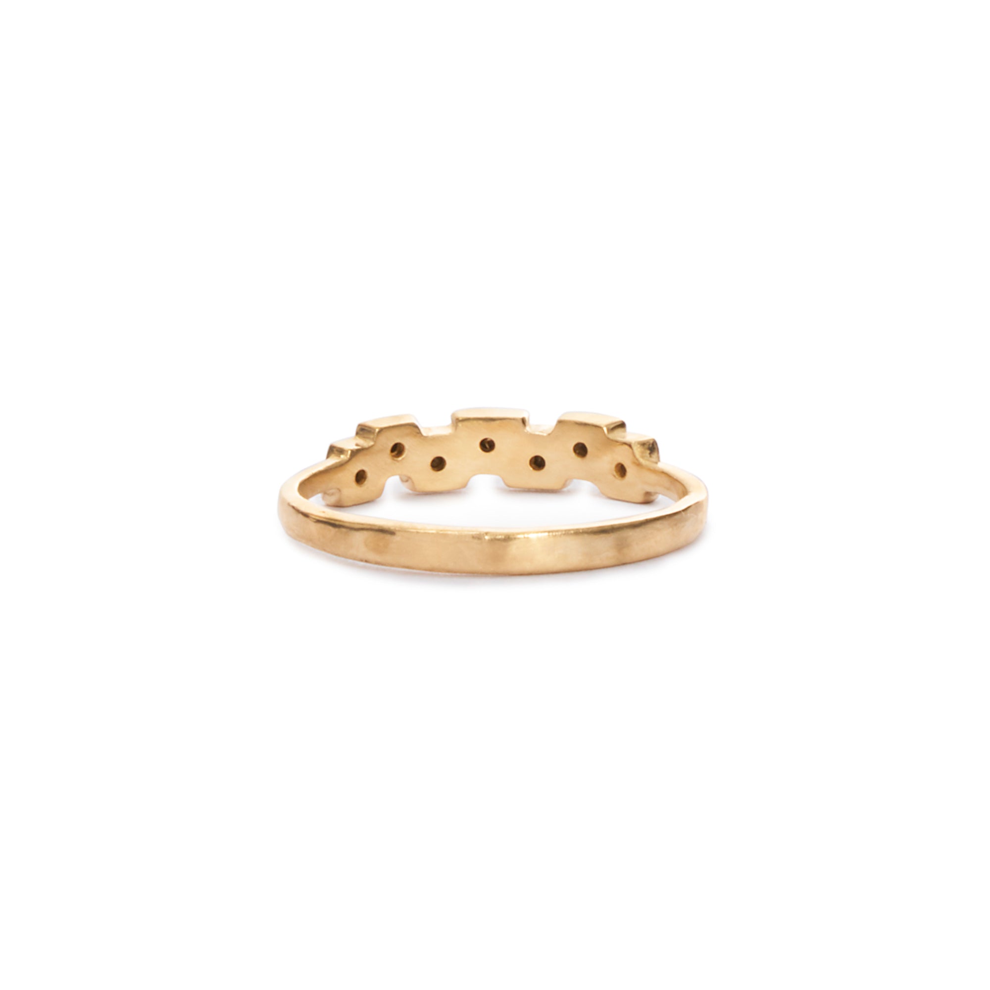 The Coral ring features 7 black diamonds flush set in textured 14k gold, with a hammered band. 