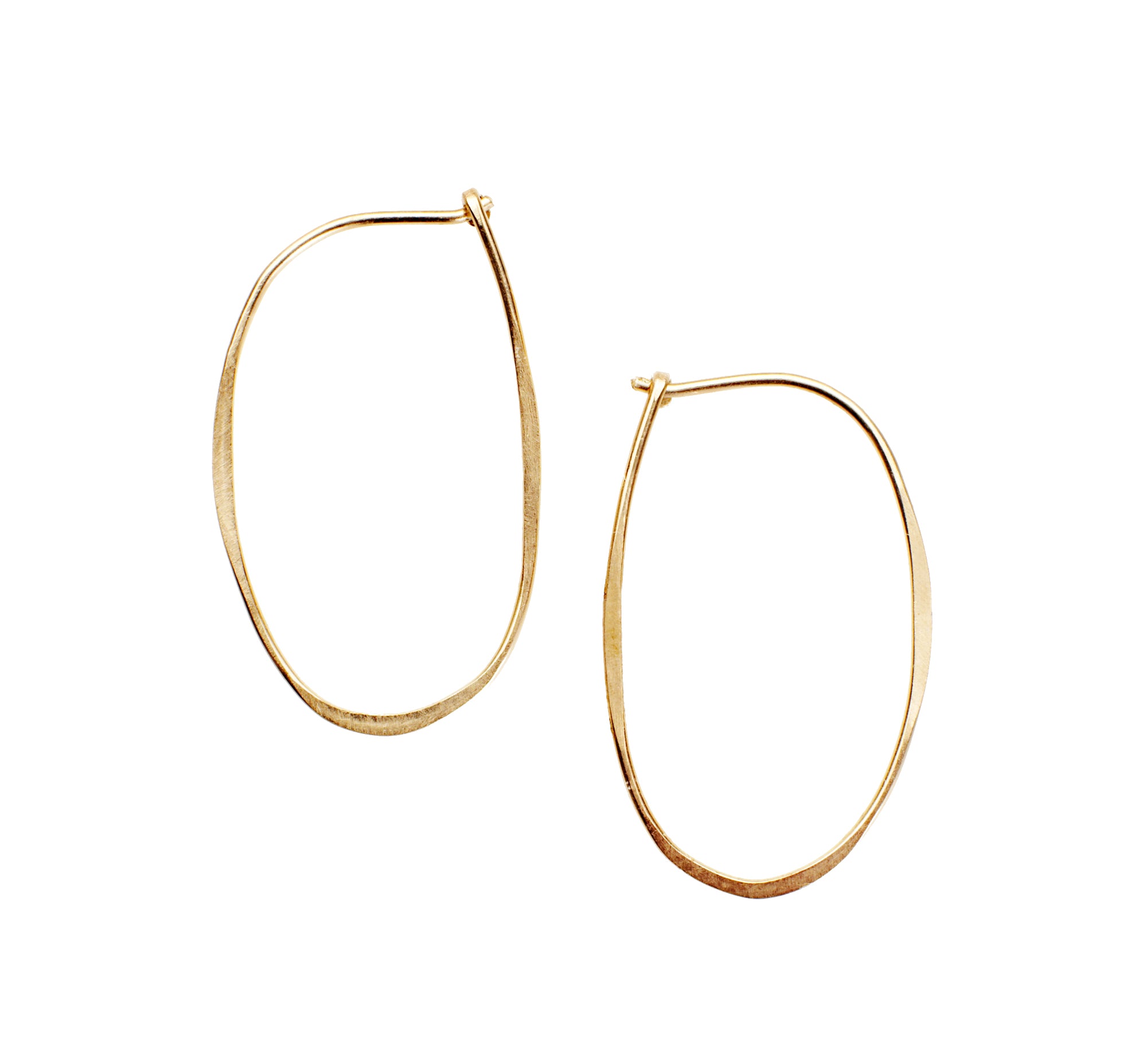 Elongated Oval Hoop, a handmade modern hoop earring made from hammered 14k gold wire finished with a hook closure.