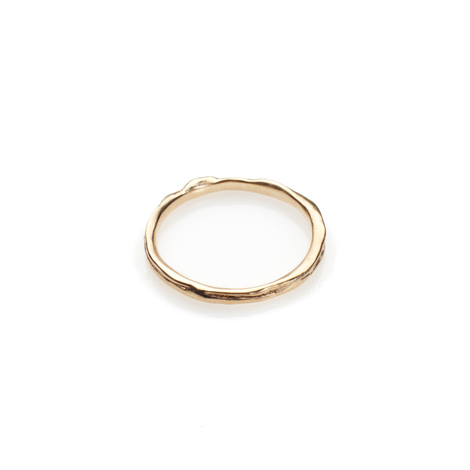 The Slip Band is thin gold ring featuring an organic texture. This subtle piece would work great stacked or worn on its own. 