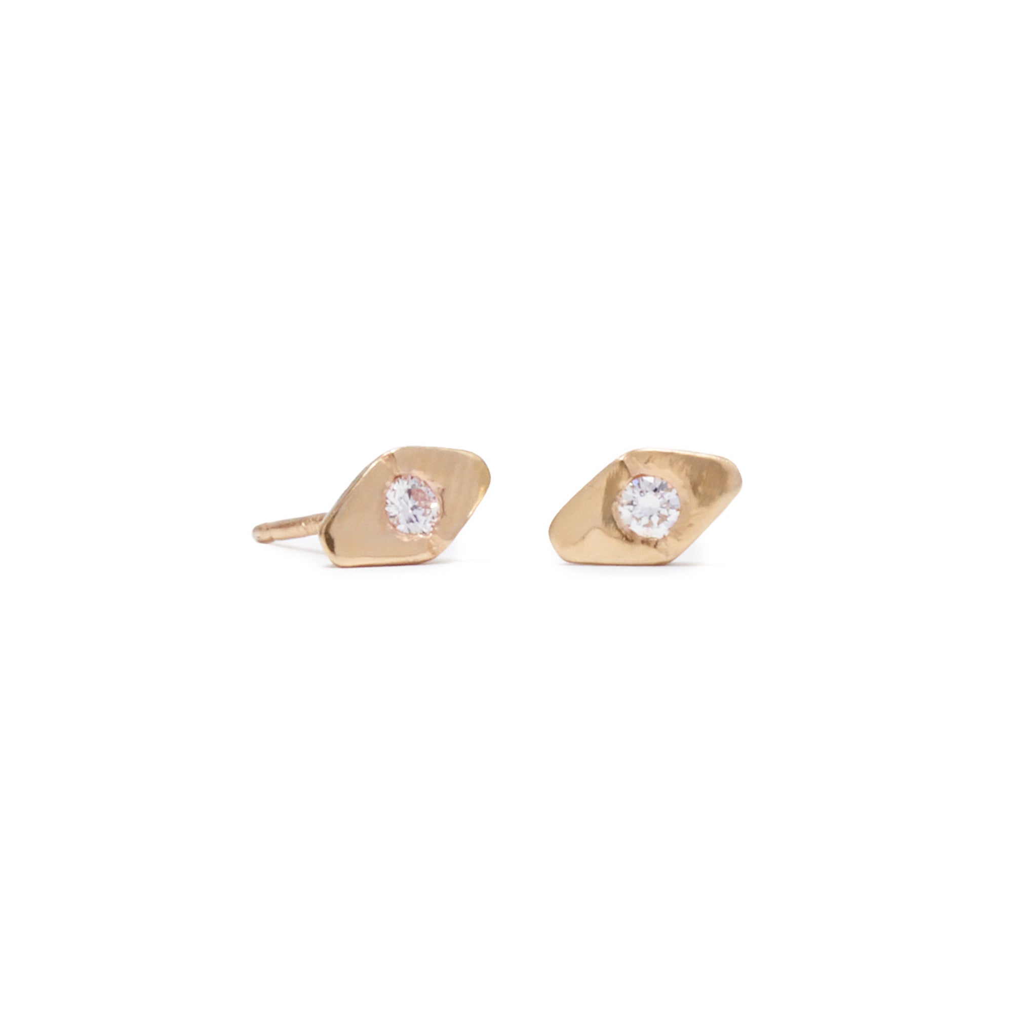 The chic Slope Studs feature a single 0.08 tcw diamond flush set in a lightly textured diamond-shaped stud.