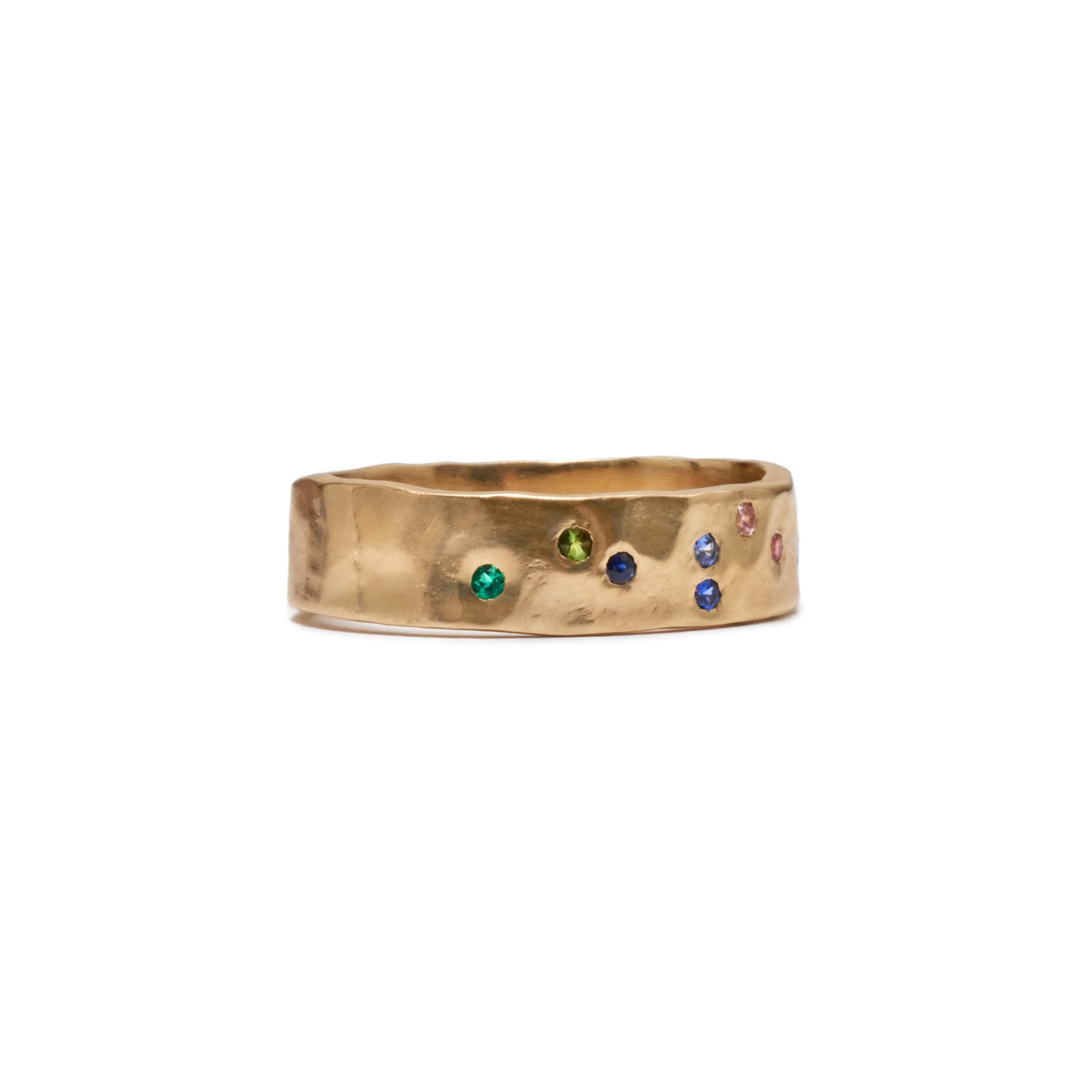 The Wide Constellation Band showcases 13 colorful sapphires and an emerald scattered across the front of a wide hammered band