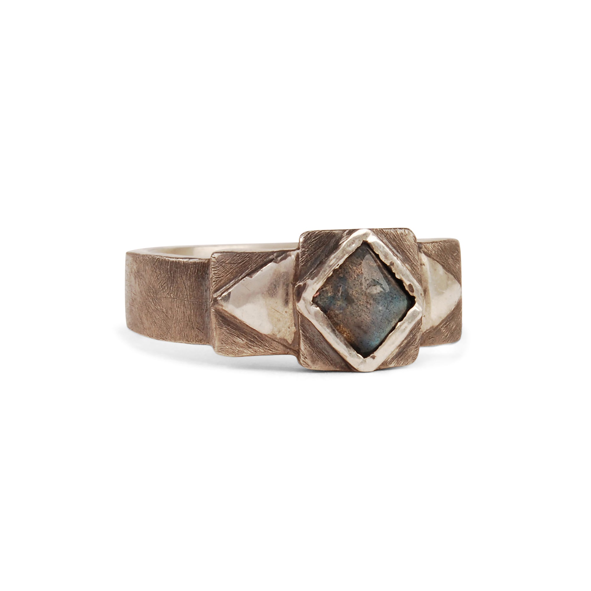 The Grit Stepped Band is crafted in sterling silver, featuring a rustic texture and oxidation and either lapis or labradorite