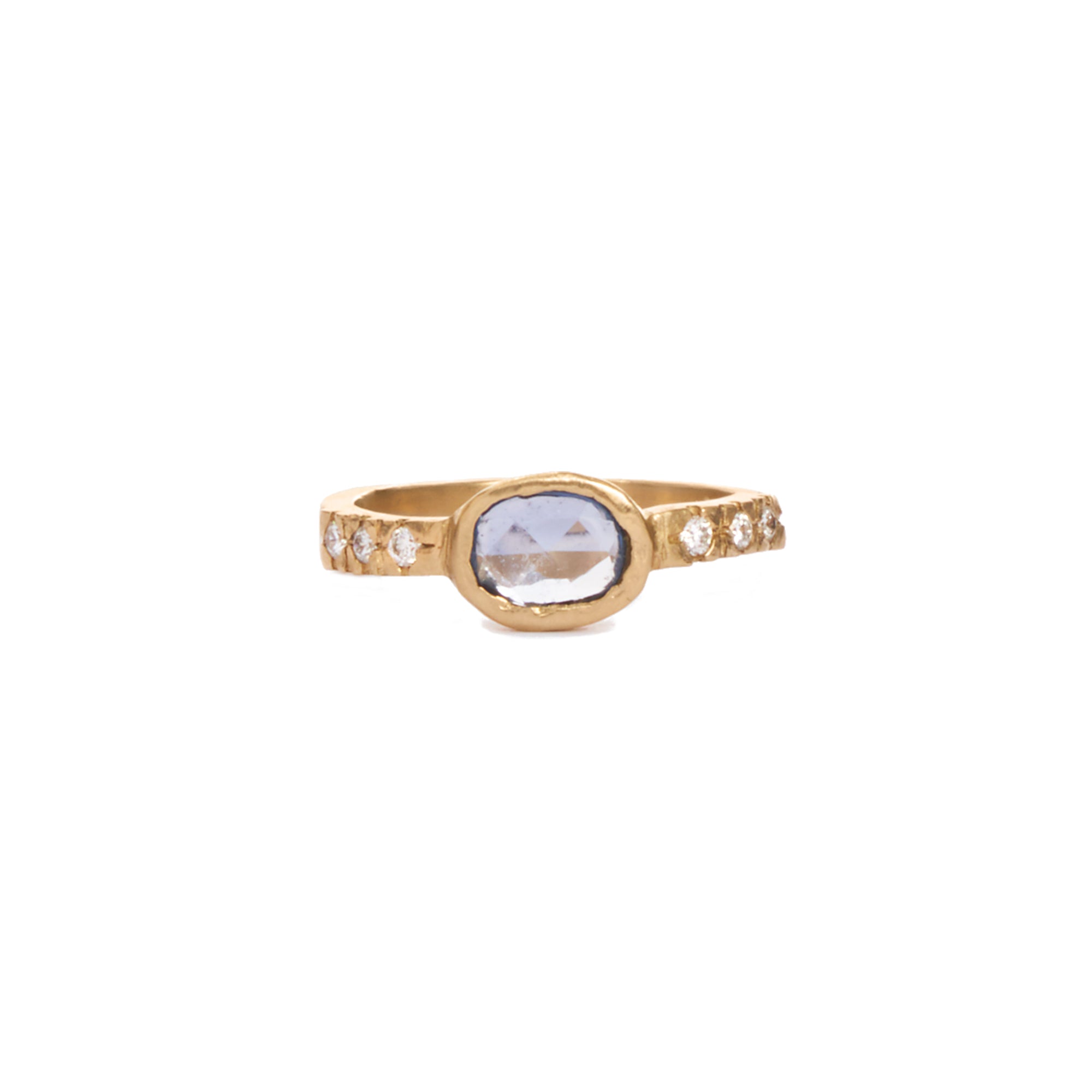 This one of a kind ring features a bezel set oval blue sapphire and six round diamonds, all set in 14k gold. 