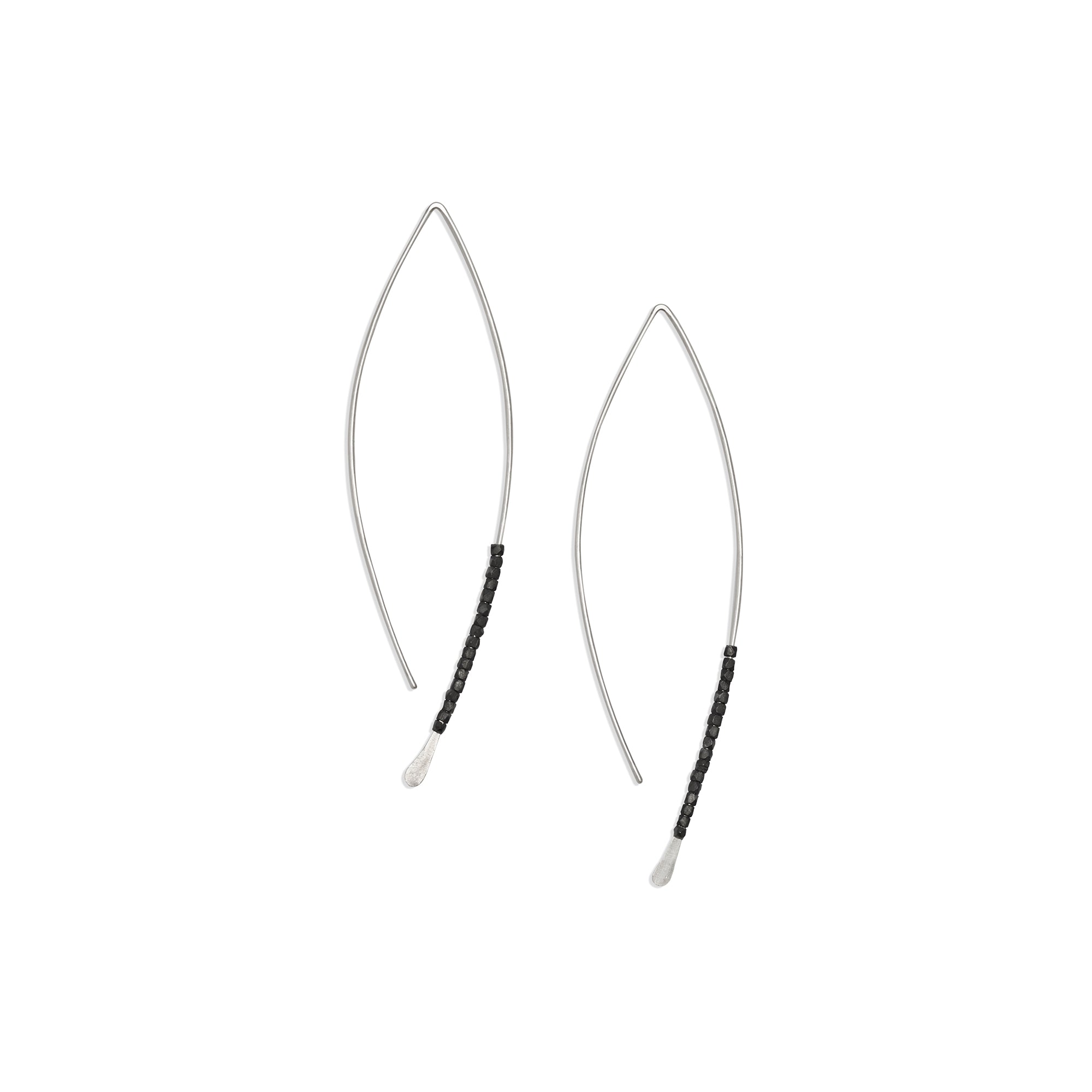The Bead Crescent Earrings feature a thin, hammered wire adorned with oxidized sterling silver beads 