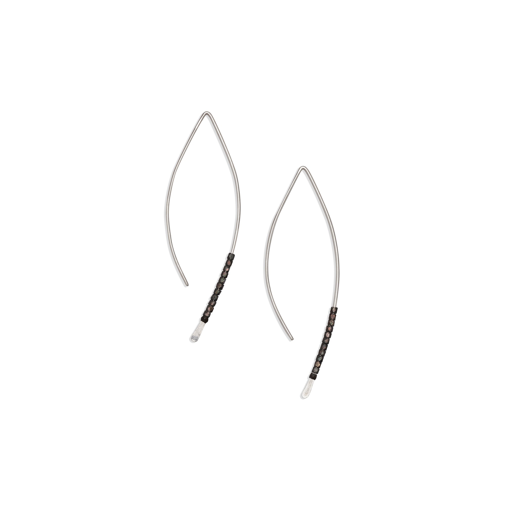The Bead Crescent Earrings feature a thin, hammered wire adorned with oxidized sterling silver beads 