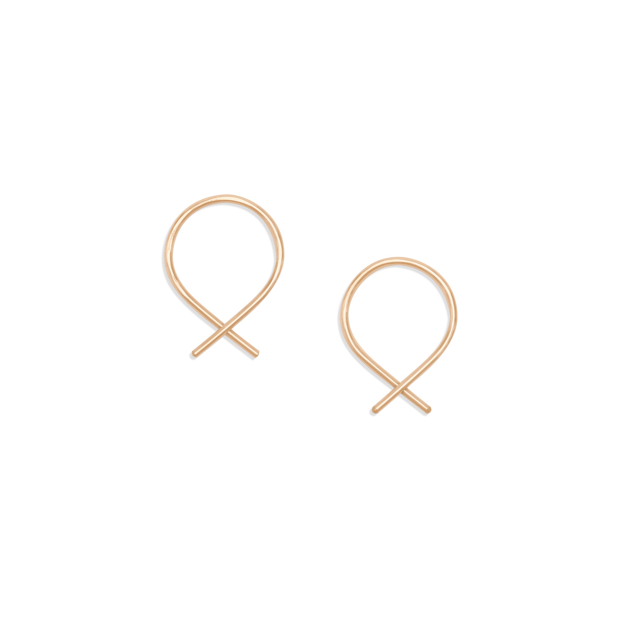 The Fish Earrings are delicate threader earrings feature 14K gold-fill or silver wire shaped into a continuous, open hoop 