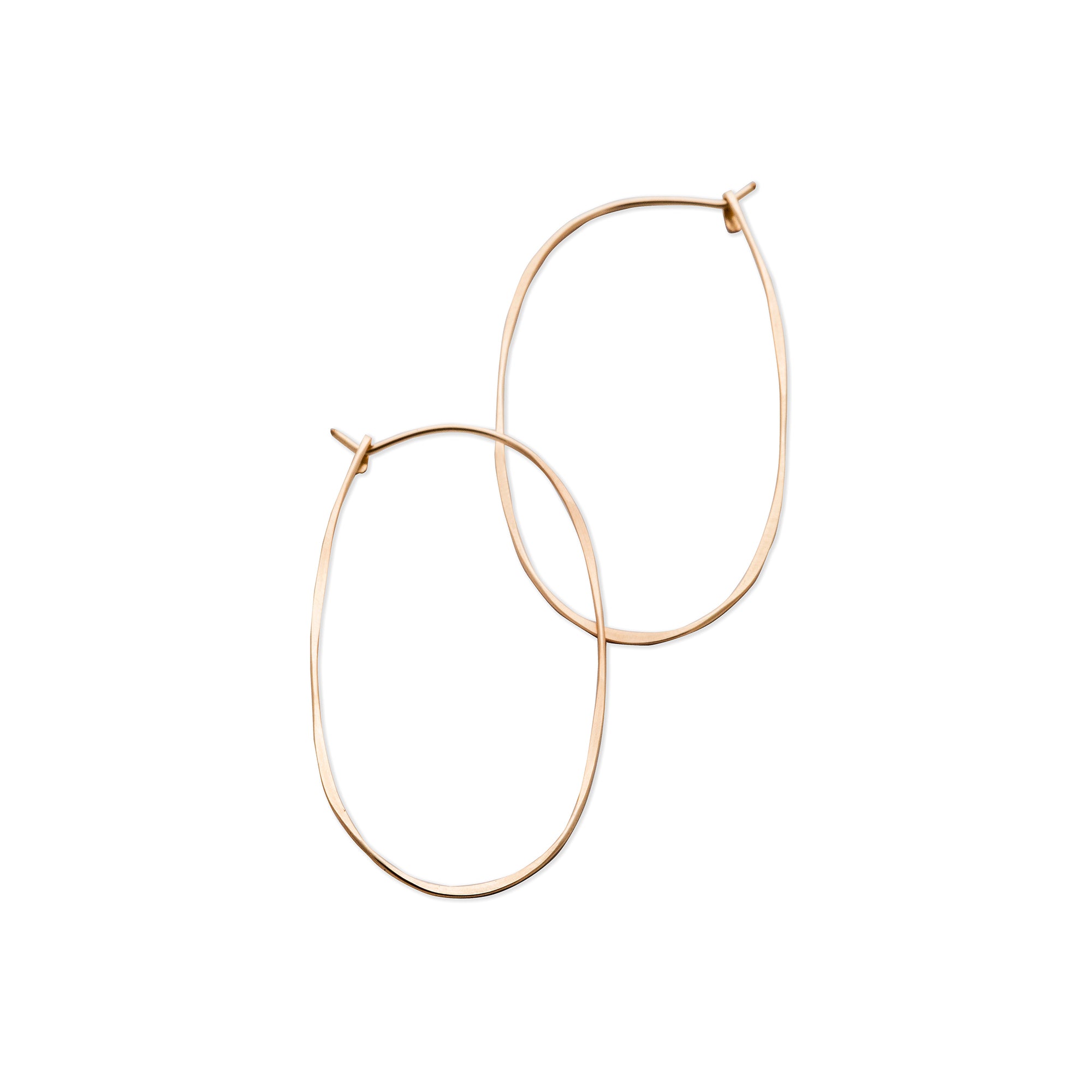 The thin Oval Hoops of hammered gold-fill or sterling silver form a continuous oval that is finished with a hook closure.