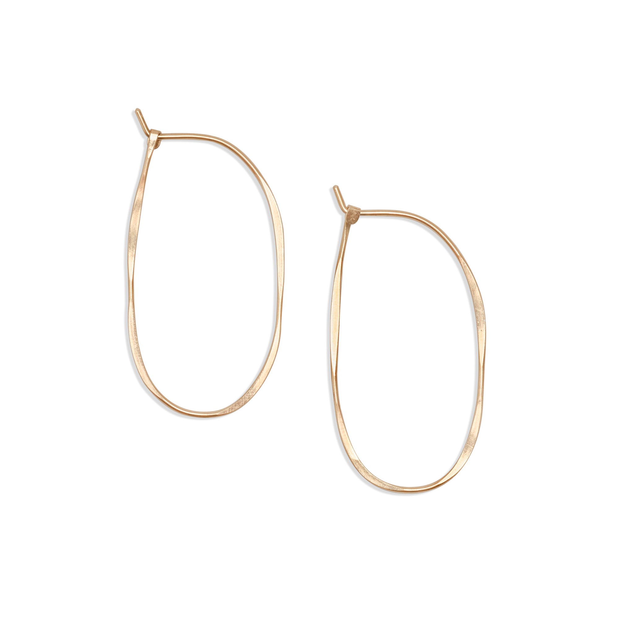 The thin Oval Hoops of hammered gold-fill or sterling silver form a continuous oval that is finished with a hook closure.